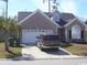 Charming single-story home with brick facade, attached garage, and well-maintained landscaping at 323 Sea Turtle Dr., Myrtle Beach, SC 29588