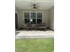 Relaxing covered patio with comfortable seating and a ceiling fan for warm days at 323 Sea Turtle Dr., Myrtle Beach, SC 29588