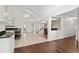 Bright living space with tile floors, a ceiling fan and open to the kitchen, with sightlines to the staircase at 437 N Boyle Dr., Pawleys Island, SC 29585