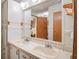 Bathroom featuring double sinks, tile countertops, a large mirror, and a wood door at 538 Calhoun Dr., Murrells Inlet, SC 29576