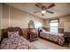 Bedroom featuring two twin beds, tile floors, a ceiling fan, and a vintage vanity with a mirror at 538 Calhoun Dr., Murrells Inlet, SC 29576
