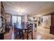 Cozy dining room featuring a chandelier, wood floors, large table, and an open view into the kitchen at 538 Calhoun Dr., Murrells Inlet, SC 29576