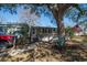 Inviting single-story home featuring a welcoming porch, lush lawn, and shaded by a mature tree at 538 Calhoun Dr., Murrells Inlet, SC 29576