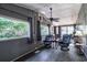 A spacious living room with comfortable seating and views of the outdoors through a large window at 538 Calhoun Dr., Murrells Inlet, SC 29576