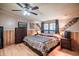 Main bedroom with a ceiling fan, wood paneling, matching nightstands, and plenty of natural light at 538 Calhoun Dr., Murrells Inlet, SC 29576