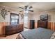 Spacious main bedroom with wood floors, a ceiling fan, ample closet space, and an adjoining bathroom at 538 Calhoun Dr., Murrells Inlet, SC 29576