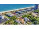 Aerial view shows proximity of condo community to a pristine beach with turquoise water and lush surroundings at 5601 N Ocean Blvd. # E-316, Myrtle Beach, SC 29577