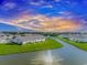 Homes surround pond with fountain during a bright sunset at 830 San Marco Ct. # C, Myrtle Beach, SC 29579