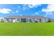 View of the backyard featuring green grass and screened-in patios at 830 San Marco Ct. # C, Myrtle Beach, SC 29579