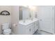 Well-lit bathroom with double sinks, white cabinetry, and a modern mirror at 830 San Marco Ct. # C, Myrtle Beach, SC 29579