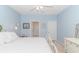 Bright bedroom with blue walls, featuring a white bed frame and a light-colored dresser at 830 San Marco Ct. # C, Myrtle Beach, SC 29579