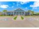 Exterior shot of the blue community clubhouse with rocking chairs and accessible parking at 830 San Marco Ct. # C, Myrtle Beach, SC 29579