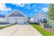 The exterior features a charming gray home with a two-car garage, lovely landscaping, and stone accents at 830 San Marco Ct. # C, Myrtle Beach, SC 29579