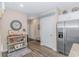 Kitchen area with stainless steel refrigerator, white cabinets, and a console table adorned with fall decorations at 830 San Marco Ct. # C, Myrtle Beach, SC 29579