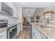Open-concept kitchen with stainless steel appliances and beautiful countertops overlooking the dining and living areas at 830 San Marco Ct. # C, Myrtle Beach, SC 29579