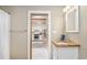Bathroom view with wood countertop vanity, modern fixtures and a doorway that leads into the bright, well-equipped kitchen at 108 N Hazard St., Georgetown, SC 29440