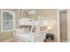 Cozy bedroom features a white bunk bed with soft, decorative pillows and a mini-split system for personalized comfort at 108 N Hazard St., Georgetown, SC 29440