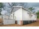 Exterior featuring white siding, dark foundation, small deck and access stairs, and mini-split system for customized comfort at 108 N Hazard St., Georgetown, SC 29440