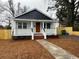 Inviting curb appeal with a well-maintained lawn and charming front porch at 108 N Hazard St., Georgetown, SC 29440
