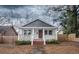 Charming home with white exterior, covered front porch, and landscaped yard at 108 N Hazard St., Georgetown, SC 29440