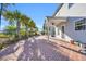 A spacious backyard featuring a brick patio, palm trees, and a well-maintained lawn, ideal for outdoor living at 217 Astoria Park Loop, Conway, SC 29526