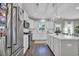 Bright white kitchen with stainless steel appliances, island, and modern lighting at 217 Astoria Park Loop, Conway, SC 29526