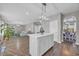 Open-concept kitchen island flowing into living and dining areas, with hardwood floors at 217 Astoria Park Loop, Conway, SC 29526