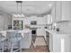 Well-lit kitchen featuring white cabinets, an island with seating, and stainless steel appliances at 217 Astoria Park Loop, Conway, SC 29526