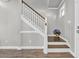 Elegant staircase with white railing and wooden steps, enhanced by natural light at 217 Astoria Park Loop, Conway, SC 29526