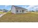 Back view of the house showing the porch and side yard at 240 Palmetto Sand Loop, Conway, SC 29527