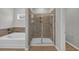 Bathroom showcasing a walk-in shower with glass door and separate soaking tub at 240 Palmetto Sand Loop, Conway, SC 29527
