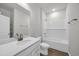 Bright bathroom featuring a bathtub, white subway tile, and a sink with modern brass fixtures at 240 Palmetto Sand Loop, Conway, SC 29527