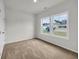 Bright bedroom with carpet, two windows, and neutral walls at 240 Palmetto Sand Loop, Conway, SC 29527