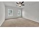 Empty bedroom featuring neutral carpeting, a ceiling fan, and natural light from the windows at 240 Palmetto Sand Loop, Conway, SC 29527
