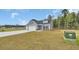 Suburban home with two car garage and manicured lawn ready for new owners at 240 Palmetto Sand Loop, Conway, SC 29527