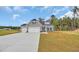 New home with a two-car garage, gray siding, and a well-manicured lawn in a suburban neighborhood at 240 Palmetto Sand Loop, Conway, SC 29527