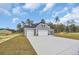 View of house featuring large driveway, a two-car garage, and manicured front lawn at 240 Palmetto Sand Loop, Conway, SC 29527