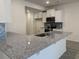 Modern kitchen with granite countertops, stainless steel appliances, gray backsplash, and white cabinetry at 240 Palmetto Sand Loop, Conway, SC 29527