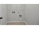 Simple laundry room with white wire shelving and connections for a washer and dryer at 240 Palmetto Sand Loop, Conway, SC 29527
