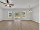 Spacious living room with wood-look flooring, a ceiling fan, and natural light at 240 Palmetto Sand Loop, Conway, SC 29527