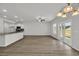 Open living area with hardwood floors connecting the kitchen, dining, and living spaces at 240 Palmetto Sand Loop, Conway, SC 29527