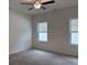 A bright bedroom with carpet flooring, ceiling fan, and two large windows at 300 Palmetto Sand Loop, Conway, SC 29527