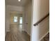 Bright entryway showcasing wood floors, white trim, and staircase, leading into an open-concept living area at 300 Palmetto Sand Loop, Conway, SC 29527