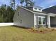 Charming home exterior featuring gray siding, stone accents, and manicured landscaping at 300 Palmetto Sand Loop, Conway, SC 29527