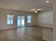 Spacious living room with wood floors, large windows, and a sliding glass door leading outside at 300 Palmetto Sand Loop, Conway, SC 29527