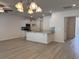 Open-concept living area with wood floors that flows seamlessly into a modern kitchen with an island at 300 Palmetto Sand Loop, Conway, SC 29527