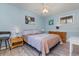 This bedroom is light and bright with decor accents, neutral colors, and light wood laminate flooring at 351 Lake Arrowhead Rd. # 24-195, Myrtle Beach, SC 29572