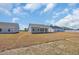 The backyard is spacious with neighboring houses under a blue sky at 432 Hallie Martin Rd., Conway, SC 29527