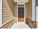 Beautiful front door with stonework and matching brown accents at 432 Hallie Martin Rd., Conway, SC 29527
