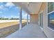 Covered patio with white columns, ceiling fans, and a view of the spacious backyard at 432 Hallie Martin Rd., Conway, SC 29527